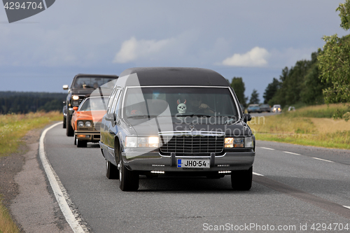 Image of Cool Cadillac Fleetwood Funeral Car on Highway