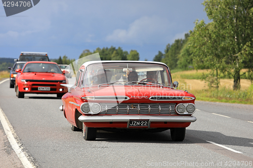 Image of Red Chevrolet Impala Car Crusing on Highway