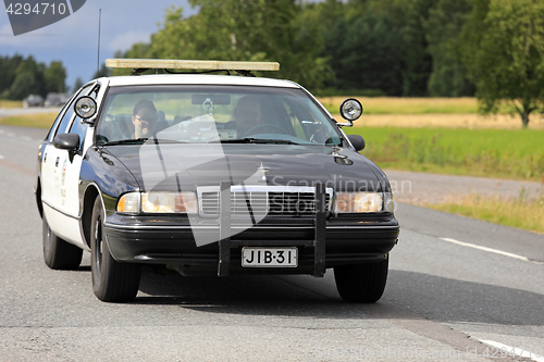 Image of American Chevrolet Police Car on Highway 