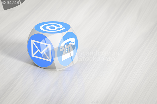 Image of turquoise cube with signs for email phone and letter