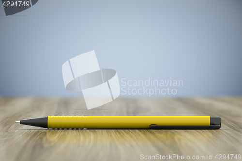 Image of a yellow pen and lots of space for your content