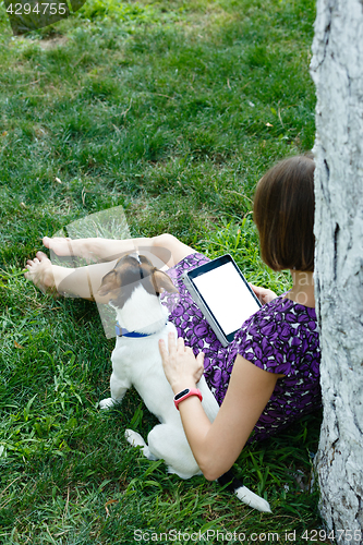 Image of Woman on grass with tablet