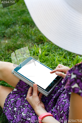 Image of Woman on grass with tablet