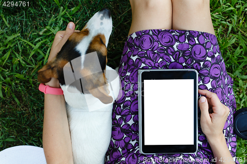 Image of Woman on grass with tablet