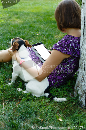 Image of Woman on grass with tablet