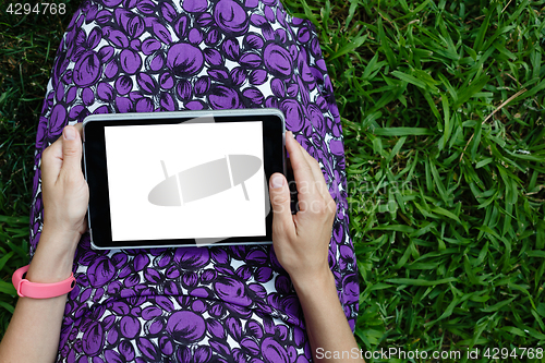 Image of Woman on grass with tablet