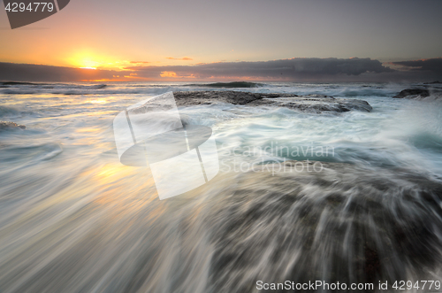 Image of Ocean flowing over rocks Bungan Beach