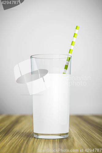 Image of a glass of milk with a green straw
