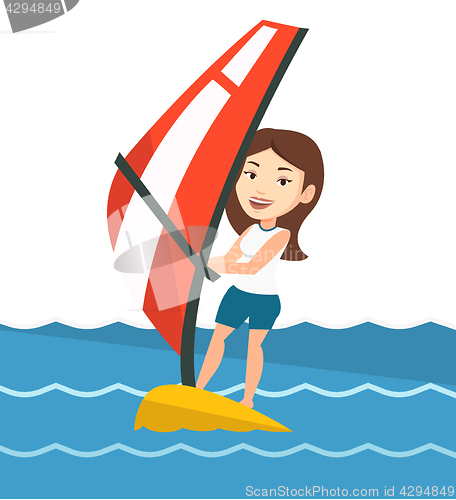 Image of Young woman windsurfing in the sea.