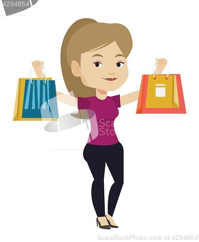 Image of Happy woman holding shopping bags.