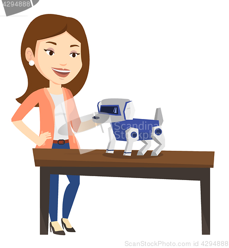 Image of Happy young woman playing with robotic dog.