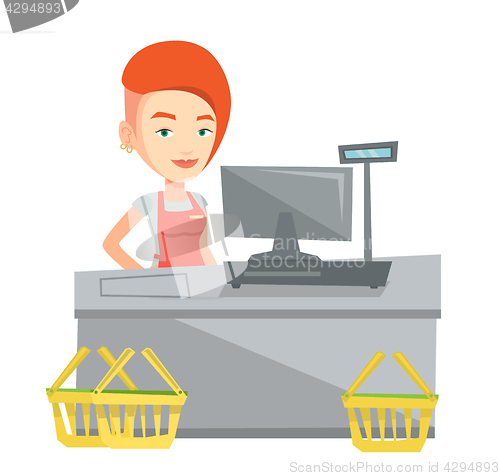 Image of Cashier standing at the checkout in supermarket.