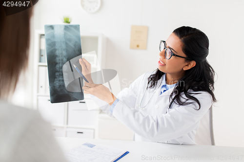 Image of doctor with x-ray of spine and patient at hospital