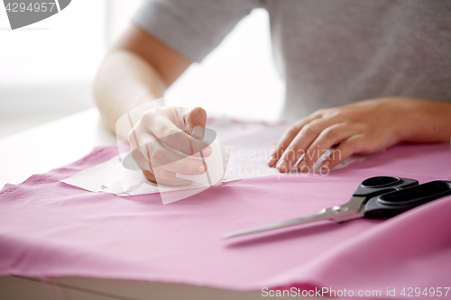 Image of woman with pattern and chalk drawing on fabric