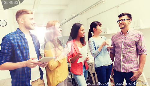 Image of creative team on coffee break talking at office