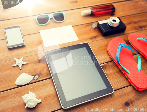 Image of close up of tablet pc and travel stuff