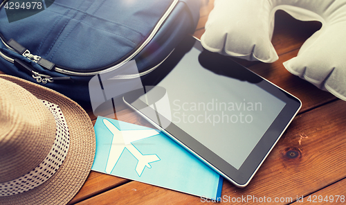 Image of close up of tablet pc and traveler personal stuff