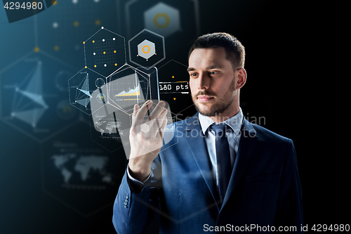 Image of businessman with smartphone and virtual holograms