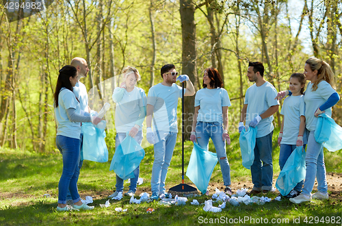 Image of group of volunteers with garbage bags in park