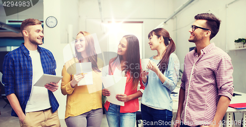 Image of creative team on coffee break talking at office