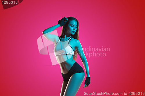 Image of Muscular young woman athlete posing at studio