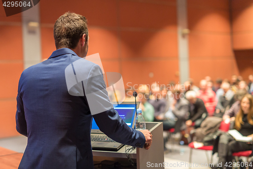 Image of Public speaker giving talk at Business Event.