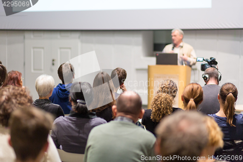 Image of Man giving presentation in lecture hall at university.