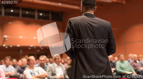 Image of Public speaker giving talk at Business Event.