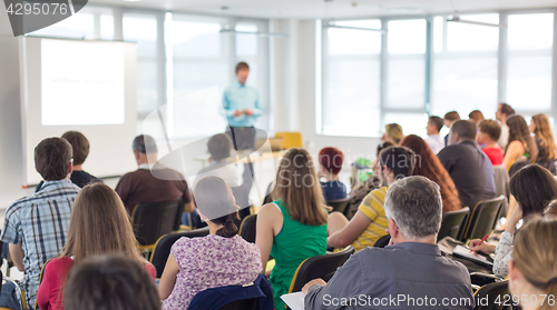 Image of Speaker giving presentation on business conference.