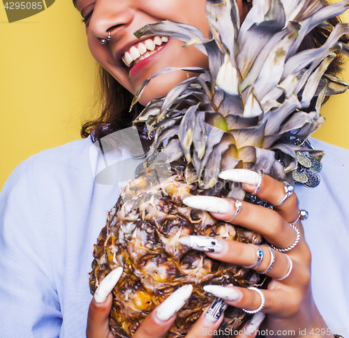 Image of lifestyle people concept. young pretty smiling indian girl with pineapple, asian summer fruits