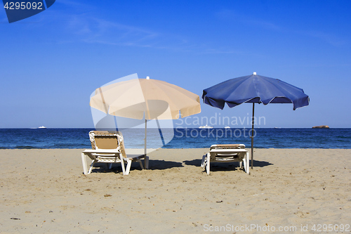 Image of Chairs and umbrellas on a beautiful sandy beach at Ibiza