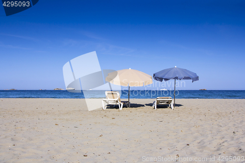 Image of Chairs and umbrellas on a beautiful sandy beach at Ibiza