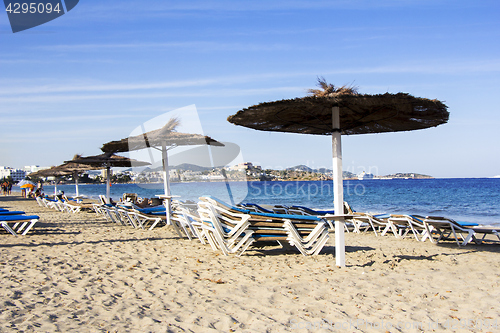 Image of Chairs and umbrellas on a beautiful sandy beach at Ibiza