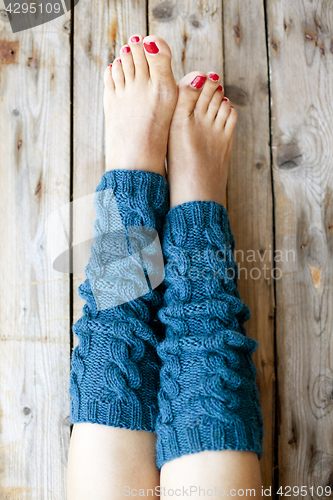 Image of Woman's legs in knitted legwarmers.
