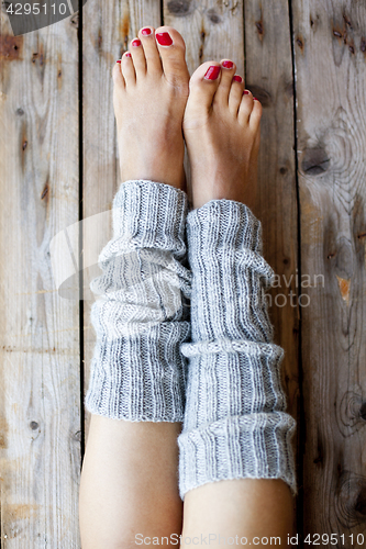 Image of Woman's legs in knitted legwarmers.