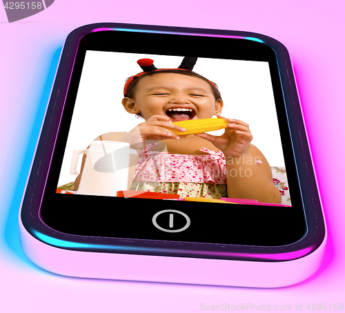Image of Girl With Toys Picture On Mobile Phone