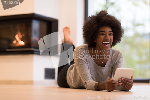 Image of black women using tablet computer on the floor