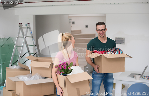 Image of young couple moving into a new home