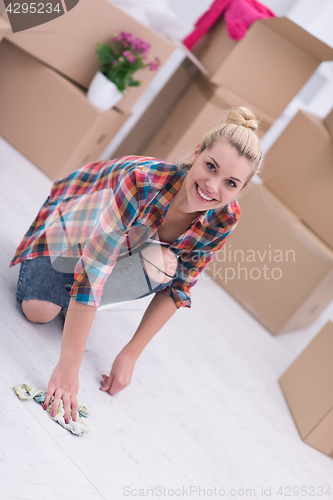 Image of woman cleaning the floor at home