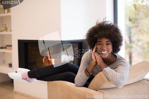 Image of black woman in front of fireplace