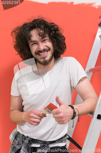 Image of man with funny hair over color background with brush