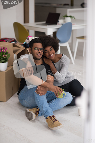 Image of African American couple relaxing in new house
