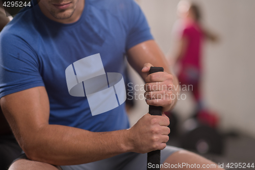 Image of young man after workout with hammer and tractor tire