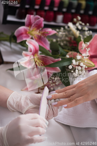 Image of Woman hands receiving a manicure