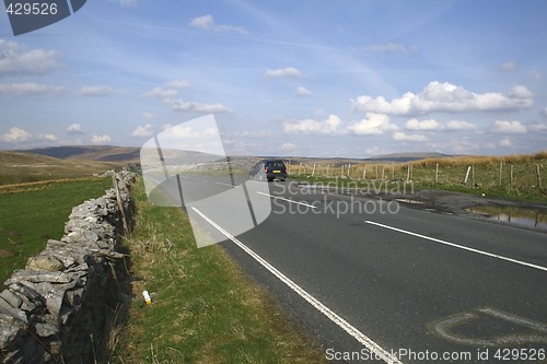 Image of country road with car