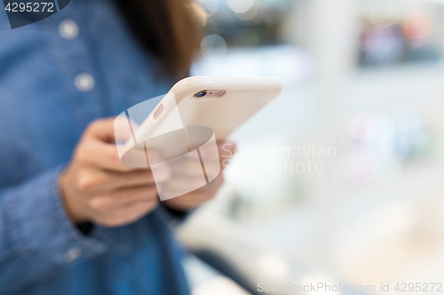 Image of Woman working on cellphone