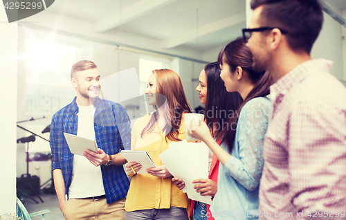 Image of creative team on coffee break talking at office