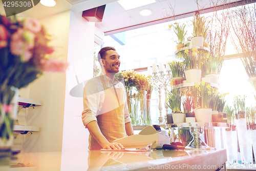 Image of florist man or seller at flower shop counter