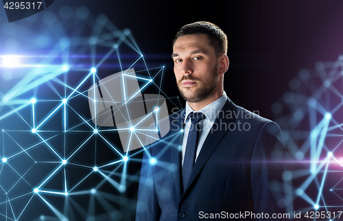 Image of businessman in suit over black