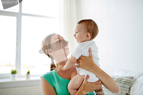 Image of happy young mother with little baby at home